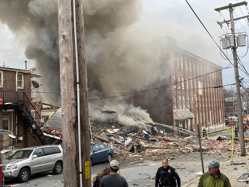 Emergency personnel work at the site of a deadly explosion at a chocolate factory in West Reading, Pa.