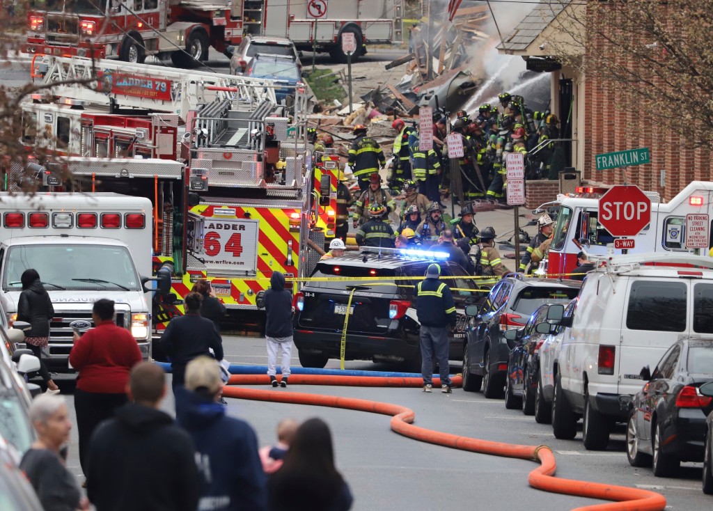 Emergency personnel work at the site of a deadly explosion at a chocolate factory in West Reading, Pa.