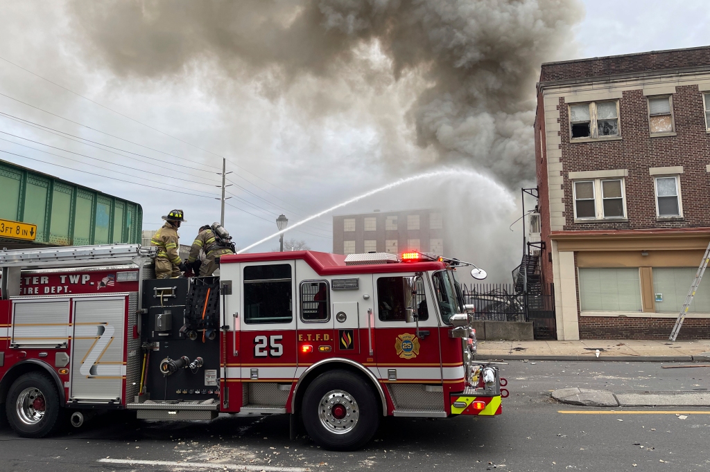 Emergency personnel work at the site of a deadly explosion at a chocolate factory in West Reading, Pa.