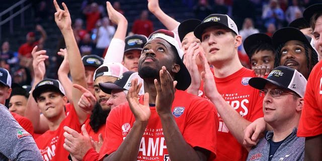 Arizona guard Courtney Ramey, center, celebrates alongside teammates after their win over UCLA in an NCAA college basketball game for the championship of the men's Pac-12 Tournament, Saturday, March 11, 2023, in Las Vegas.