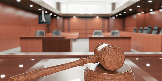 Inside a courtroom with gavel in plain view. 