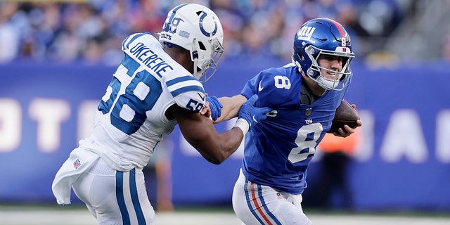 Daniel Jones #8 of the New York Giants in action against Bobby Okereke #58 of the Indianapolis Colts at MetLife Stadium on January 01, 2023 in East Rutherford, New Jersey. The Giants defeated the Colts 38-10.