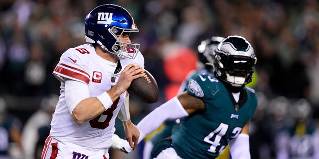 New York Giants quarterback Daniel Jones, left, runs with the ball as Philadelphia Eagles linebacker Kyzir White chases him during the first half of an NFL divisional round playoff football game, Saturday, Jan. 21, 2023, in Philadelphia.