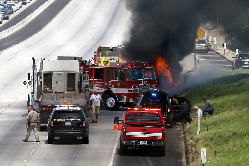 Van Dykes burning sports car on the side of the 101 Freeway in on Aug. 19, 2013.