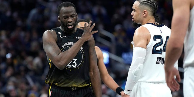 Draymond Green (23) of the Golden State Warriors and Dillon Brooks (24) of the Memphis Grizzlies exchange words during the second quarter at Chase Center Dec. 25, 2022, in San Francisco.