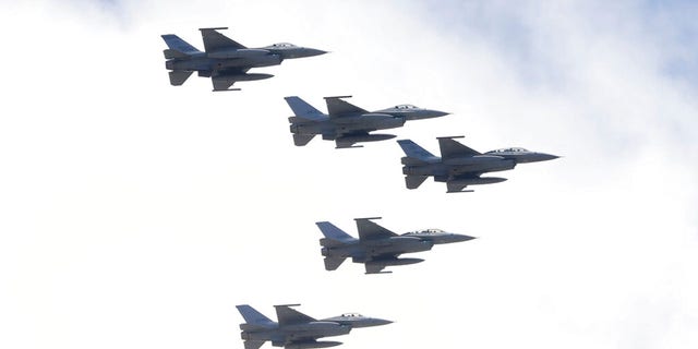 FILE: Taiwan's F-16 fighter jets fly in close formation over President Office during National Day celebrations in front of the Presidential Building in Taipei, Taiwan, Oct. 10, 2021. 