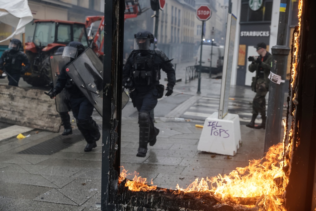 Riot police scuffle with protesters during a protest in Rennes, western France, on March 22, 2023.