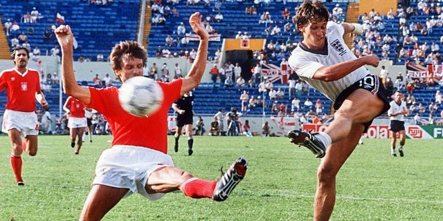 English forward Gary Lineker, right, kicks the ball past Polish defender Stefan Majewski during the World Cup first round soccer match between England and Poland, June 11, 1986 in Monterrey, Mexico.