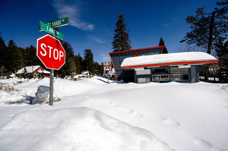 Snowdrifts that consumed buildings and street signs following the winter storm that hit Crestline, California.