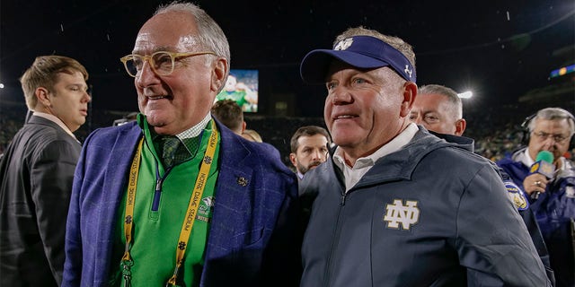 Athletic Director Jack Swarbrick and Head coach Brian Kelly of the Notre Dame Fighting Irish speak following the game against the Stanford Cardinal at Notre Dame Stadium on September 29, 2018 in South Bend, Indiana.