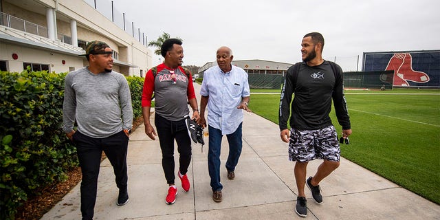 Juan Centeno, #68, former pitcher Pedro Martinez, former director of the Boston Red Sox Dominican Academy Jesús Alou, and Eduardo Rodriguez, #57 of the Boston Red Sox, exit JetBlue Park at Fenway South before going fishing after a team workout on March 5, 2019, in Sanibel, Florida. 