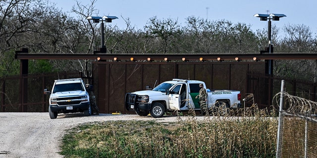 U.S. Border Patrol monitor on the bank of the Rio Grande near the Gateway International Bridge, between the cities of Brownsville, Texas, and Matamoros, Tamaulipas, Mexico, on March 16, 2021, in Brownsville, Texas.