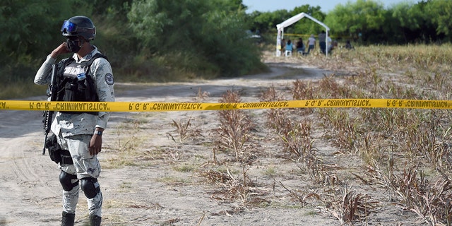 A member of the National Guard guards the entrance to a property called "La Bartolina" in the border city of Matamoros, Tamaulipas state, Mexico on Aug. 23, 2021.