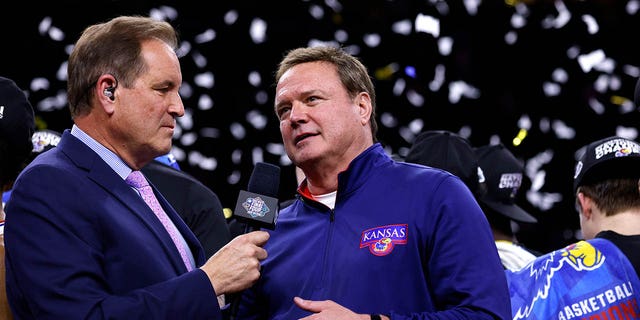 Jim Nantz (L) interviews head coach Bill Self of the Kansas Jayhawks following their victory against the North Carolina Tar Heels during the 2022 NCAA Men's Basketball Tournament Final Four Championship at Caesars Superdome on April 4, 2022, in New Orleans, Louisiana. 