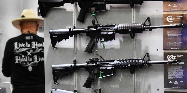 Colt M4 Carbine and AR-15 style rifles are displayed during the National Rifle Association (NRA) Annual Meeting at the George R. Brown Convention Center, in Houston on May 28, 2022. 