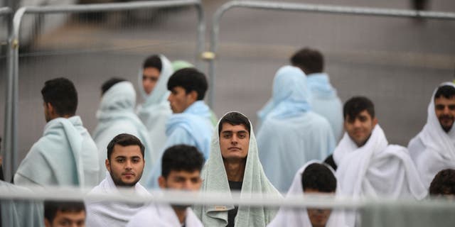 Detainees are seen wrapped in blankets inside the holding center for migrants, near Ramsgate, southeast England, on Nov. 3, 2022.