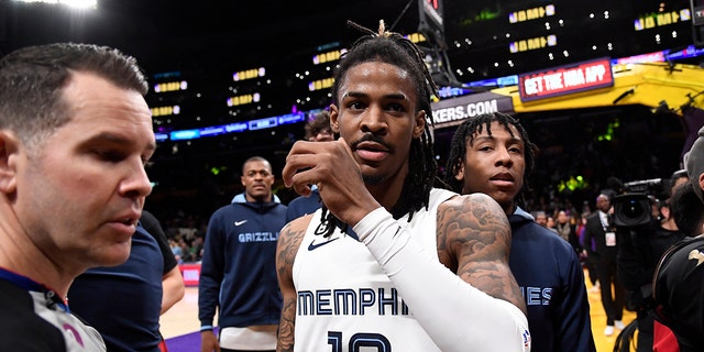 Ja Morant #12 of the Memphis Grizzlies is restrained by the referee after a verbal altercation with Shannon Sharpe during the halftime against the Los Angeles Lakers at Crypto.com Arena on January 20, 2023 in Los Angeles, California. 