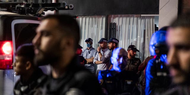 Israeli police stand guard outside Sara Netanyahu's hair salon after protesters gathered outside the building.