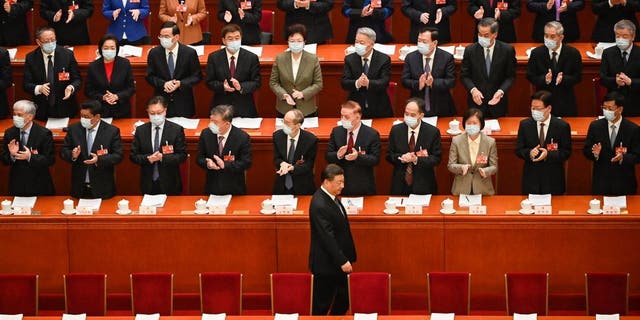 China's President Xi Jinping, bottom center, arrives for the second plenary session of the National People's Congress with other Chinese leaders at the Great Hall of the People in Beijing on March 7, 2023.