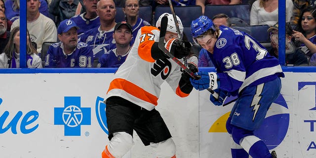 Philadelphia Flyers defenseman Tony DeAngelo, #77, and Tampa Bay Lightning left wing Brandon Hagel, #38, during the NHL Hockey match between the Tampa Bay Lightning and Philadelphia Flyers on March 7, 2023 at Amalie Arena in Tampa, Florida.