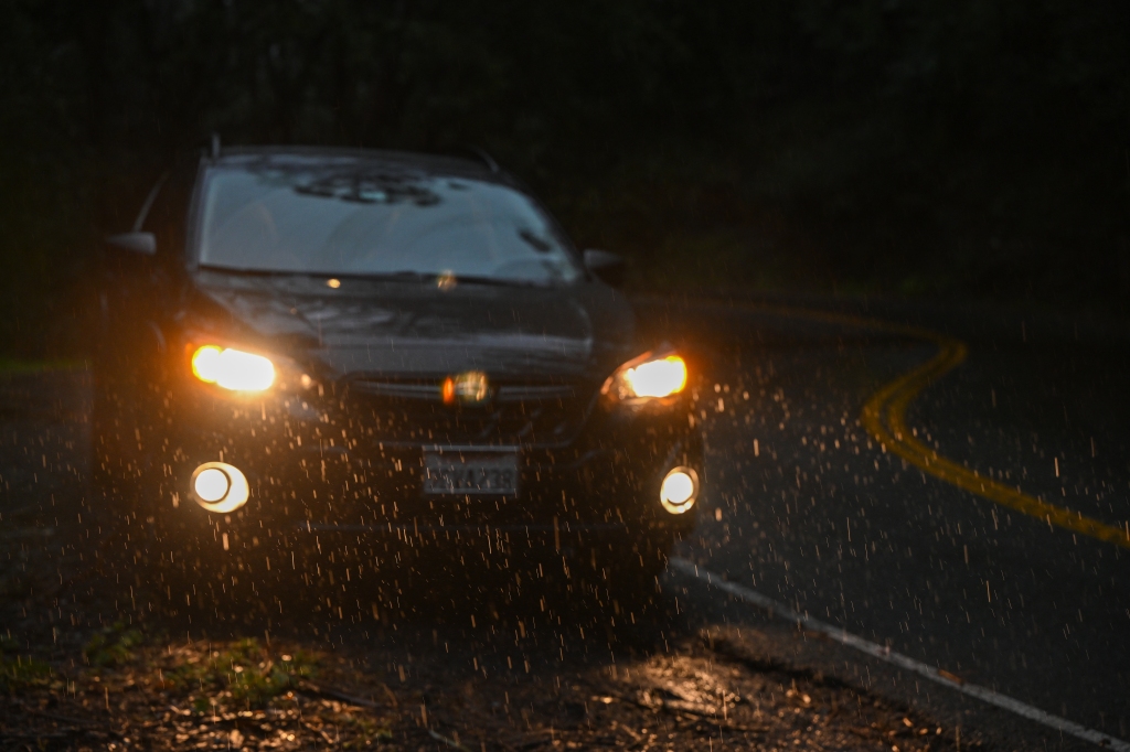 A car is seen on Highway 1 of Point Reyes during heavy rain in Inverness, California on March 9, 2023.