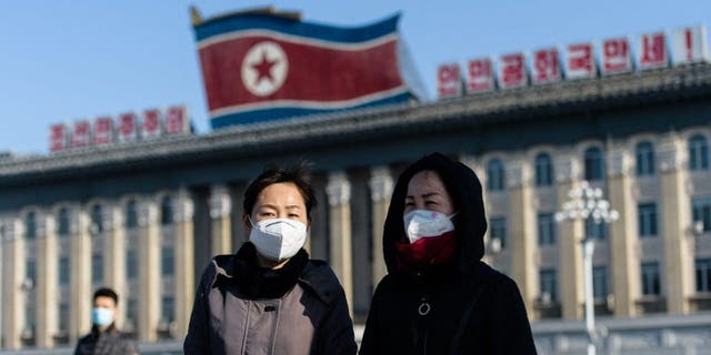 Pedestrians walk in Kim Il Sung Square in Pyongyang