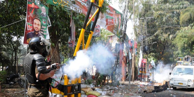 Pakistani security forces clash with supporters of former Prime Minister Imran Khan outside his residence to prevent his possible arrest in Lahore, Pakistan, on March 15, 2023.