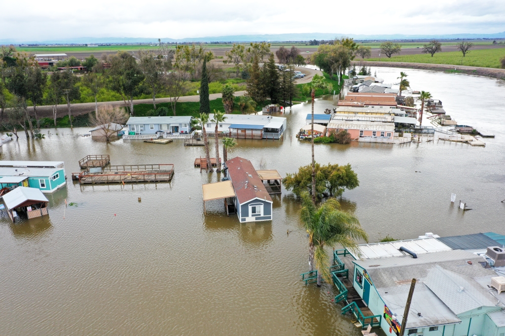 An aerial view shows homes under water after levee fails in Manteca of San Joaquin County in Calif., on March 21, 2023. 