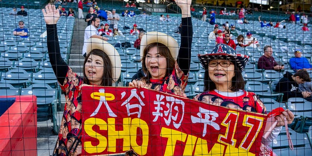 Fans of Shohei Ohtani, from left, Harue Boyle, Sae Koines and Eriko Inoue, hope to catch a glimpse of their favorite player before a Freeway Series exhibition game between the Angels and Dodgers at Angel Stadium in Anaheim on Monday, March 27, 2023. 