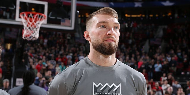 Domantas Sabonis of the Sacramento Kings stands for the national anthem on March 29, 2023, at the Moda Center Arena in Portland, Oregon.