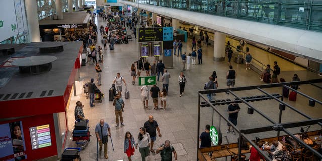 Travelers at Arrivals Hall of Terminal 1 in Humberto Delgado International Airport Aug. 27, 2022, in Lisbon, Portugal. 