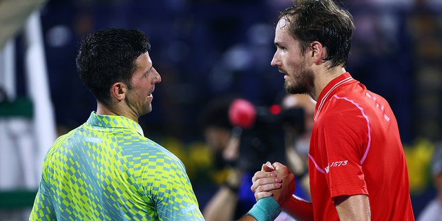 Novak Djokovic of Serbia shakes hands with Daniil Medvedev after being defeated by him during day thirteen of the Dubai Duty Free Tennis at Dubai Duty Free Tennis Stadium on March 03, 2023, in Dubai, United Arab Emirates.