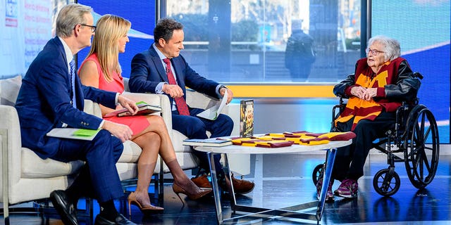 Hosts Steve Doocy, Ainsley Earhardt and Brian Kilmeade with Jean Dolores Schmidt, also known as Sister Jean, as she visits "Fox and Friends" at Fox News Studios March 7, 2023, in New York City.