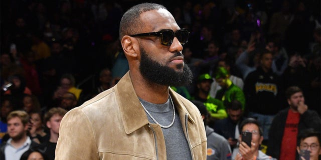 Injured LeBron James watches his Lakers take on the Phoenix Suns at Crypto.com Arena on March 22, 2023, in Los Angeles.