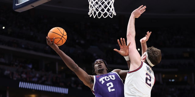 Emanuel Miller #2 of the TCU Horned Frogs drives to the basket against Drew Timme #2 of the Gonzaga Bulldogs during the second half in the second round of the NCAA Men's Basketball Tournament at Ball Arena on March 19, 2023 in Denver, Colorado.