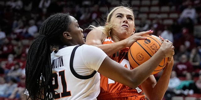 Miami's Haley Cavinder, #14, is defended by Oklahoma State's Terryn Milton, #21, during the first half of a first-round college basketball game in the women's NCAA Tournament Saturday, March 18, 2023, in Bloomington, Indiana.