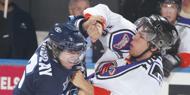 Erick Tremblay of Rimouski Oceanique, left, fights Nick Fugere of the Gatineau Olympiques during a Quebec Major Junior Hockey League game at Robert Guertin Arena in Gatineau, Quebec, Canada, on Nov. 13, 2004.