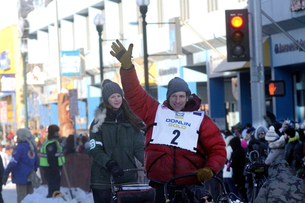 Musher Jessie Holmes of Brushkana, Alaska, waves to the crowd during the Iditarod Trail Sled Dog Race's ceremonial start in downtown Anchorage, Alaska, on Saturday, March 4, 2023. 