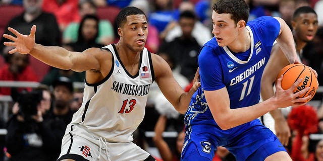 Creighton center Ryan Kalkbrenner (11) moves the ball against San Diego State forward Jaedon LeDee (13) in the first half of a Elite 8 college basketball game in the South Regional of the NCAA Tournament, Sunday, March 26, 2023, in Louisville, Ky.