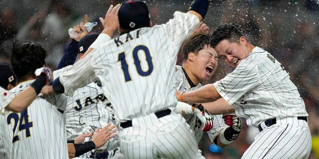 Japan players celebrate after defeating Mexico in a World Baseball Classic game, Monday, March 20, 2023, in Miami.