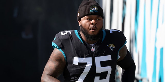 Jawaan Taylor #75 of the Jacksonville Jaguars is introduced during the game against the Dallas Cowboys at TIAA BANK Stadium on December 18, 2022 in Jacksonville, Florida.