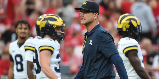 Head coach Jim Harbaugh of the Michigan Wolverines walks the field before the game against the Nebraska Cornhuskers at Memorial Stadium on October 9, 2021 in Lincoln, Nebraska.