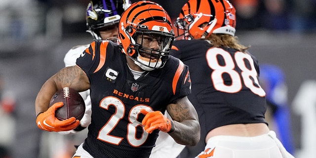 Joe Mixon #28 of the Cincinnati Bengals runs the ball against the Baltimore Ravens during the first quarter in the AFC Wild Card playoff game at Paycor Stadium on January 15, 2023 in Cincinnati, Ohio.