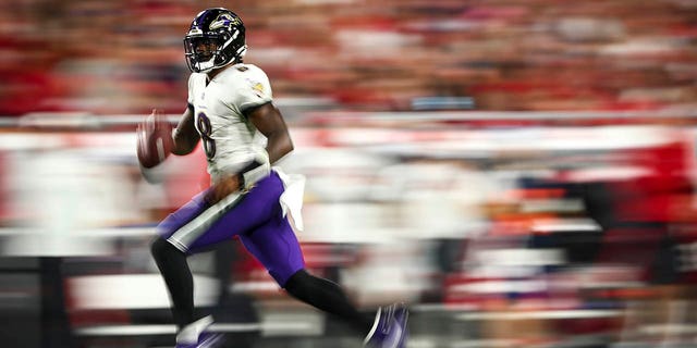 Lamar Jackson, #8 of the Baltimore Ravens, carries the ball during the fourth quarter of an NFL football game against the Tampa Bay Buccaneers at Raymond James Stadium on Oct. 27, 2022 in Tampa, Florida. 