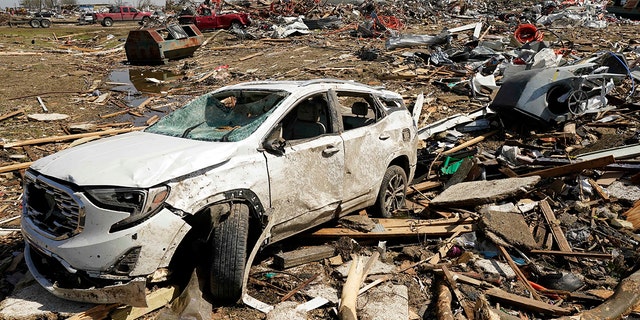 A vehicle awaits removal on Saturday after getting destroyed by a Friday night tornado that hit Rolling Fork, Miss.