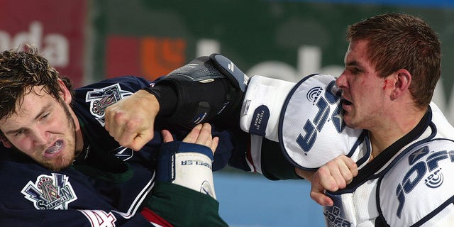 Marty Doyle of the Shawinigan Cataractes, left, and David Starenky of the Gatineau Olympiques fight during a Quebec Major Junior Hockey game at Robert-Guertin Center in Gatineau, Quebec, Canada, on Oct. 22, 2004.