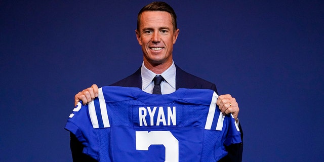 Indianapolis Colts quarterback Matt Ryan holds his new jersey after a press conference at the NFL team's practice facility in Indianapolis March 22, 2022.