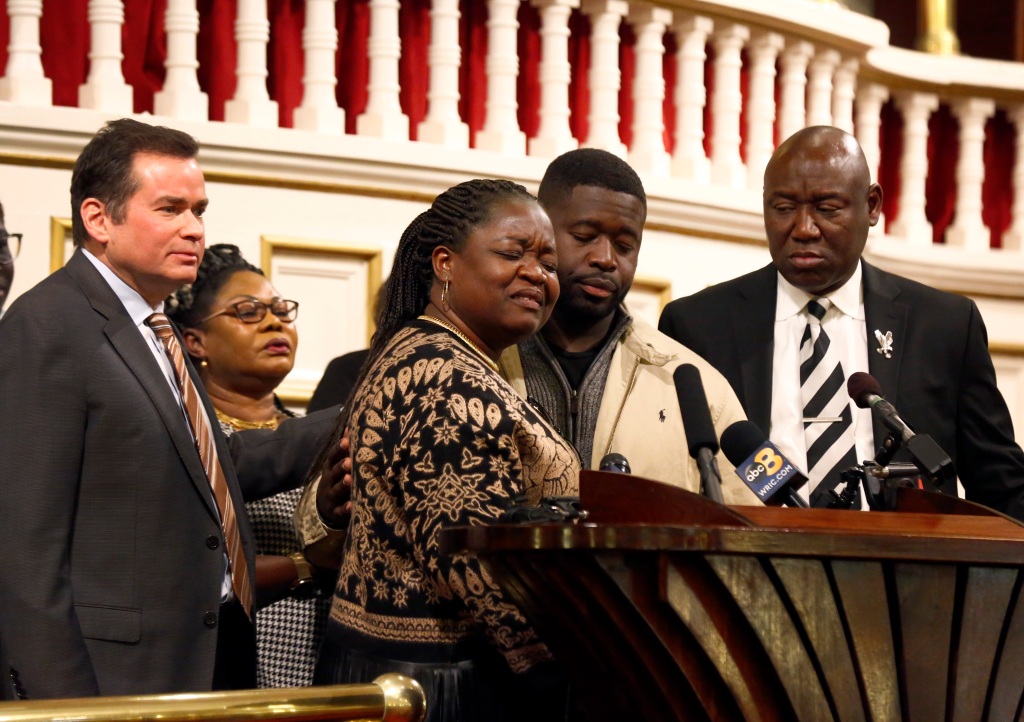 Caroline Ouko (center left) mother of Irvo Otieno, speaks of her son with attorney Mark Krudys (left) her older son, Leon Ochieng (center right), and attorney Ben Crump (right) at First Baptist Church of South Richmond on March 21, 2023. 