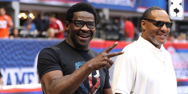 Former Miami Hurricanes wide receiver Michael Irvin reacts to Hurricanes fans on the sideline before their game against the Alabama Crimson Tide at Mercedes-Benz Stadium.