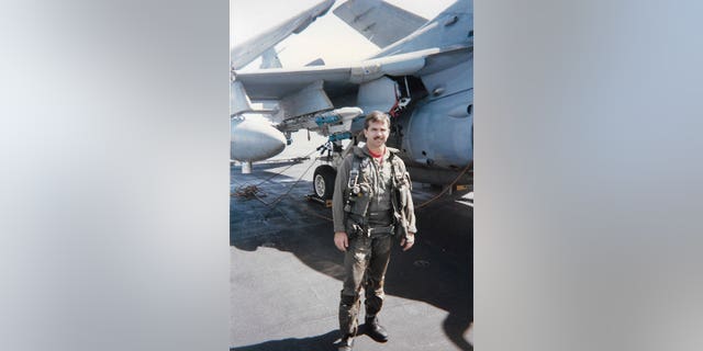 Navy A-6 Intruder pilot Jim Seaman standing in front of his jet. He passed away from lung cancer at age 61 in 2018. 